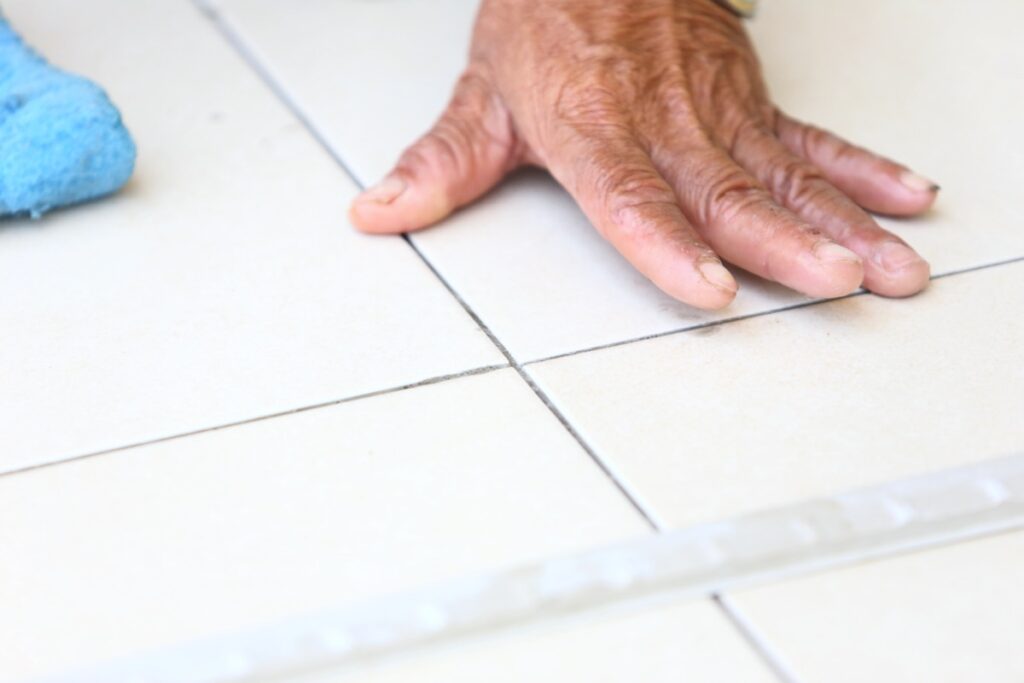 man installing tile flooring